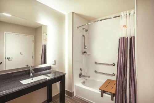 a bathroom with a sink and a tub and a shower at La Quinta by Wyndham Memphis Downtown in Memphis