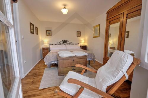 a bedroom with a bed and two chairs in it at Casona del Sol El Retorno I in Lastres