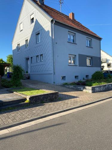 a white building with windows on the side of a street at Ferienhaus MaLu in Nonnweiler