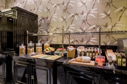 a buffet with food and drinks on a table at Room Mate Anna, Barcelona in Barcelona