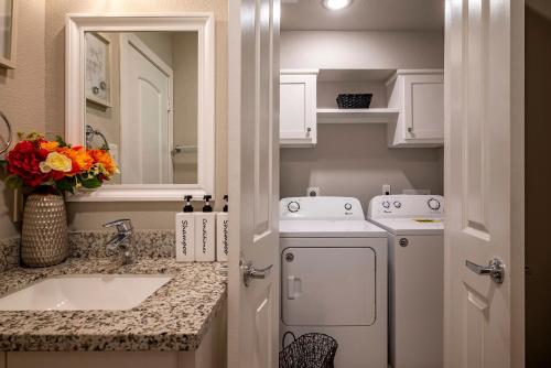 a kitchen with a sink and a washing machine at 2 Galleria Downtown 3BR Free Parking Summer Time in Houston