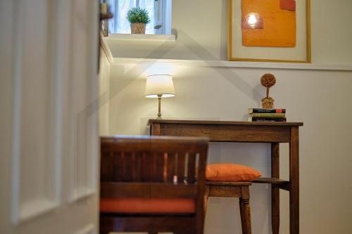 a chair sitting next to a desk with a lamp at Casona del Sol El Retorno I in Lastres