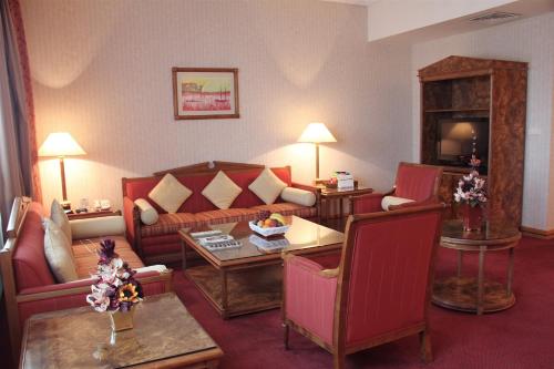 a living room with a couch and a table at Capitol Hotel Jumeirah Dubai in Dubai