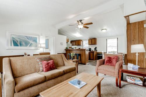 a living room with a couch and a table at Gamecock Roost- 15mins to Downtown- Back unit in Columbia