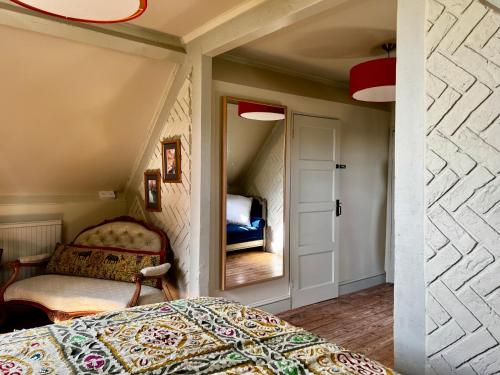 a bedroom with a bed and a mirror at Eclectic Barn - Pergola & Dog-Friendly Garden in Calne