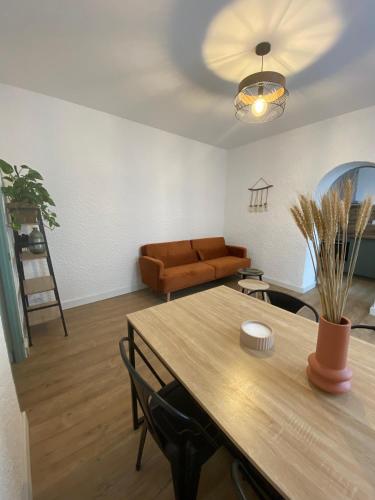 a living room with a table and a couch at La Suite des Platanes in Perpignan