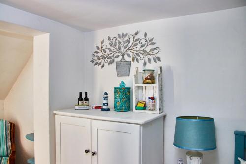 a room with a white cabinet with a blue lamp at Gilcrest Place Guest House in Paternoster