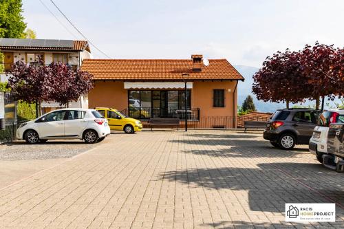 a parking lot with cars parked in front of a building at Casa Valentino - Appartamento con vista in Madonna del Sasso