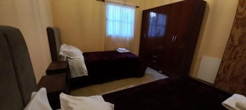 a bedroom with a bed and a dresser and a mirror at Departamentos Tilcara in Tilcara