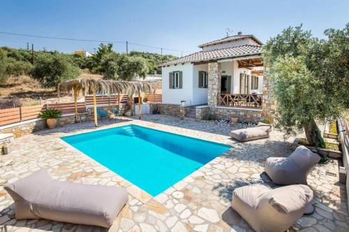 a villa with a swimming pool in front of a house at Villa Luna in Kavála