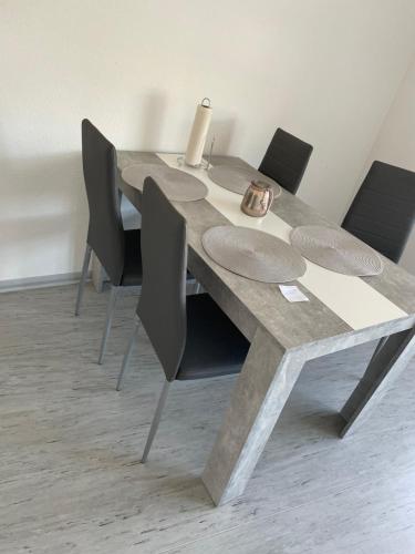 a table with chairs and a candle on top of it at Ferienwohnung in Celle