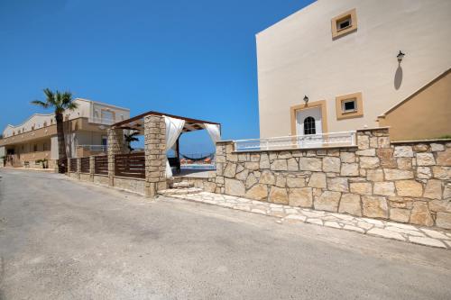 a stone wall on the side of a building at Sunrise Apartments in Sfakaki