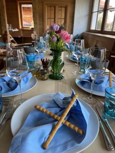 a table with plates and utensils on top of it at Hotel Maier zum Kirschner in Rottach-Egern