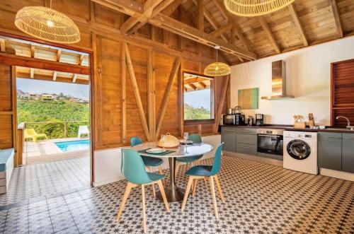 a kitchen and dining room with a table and chairs at Bungalow La Coulée d'Or in Le Vauclin