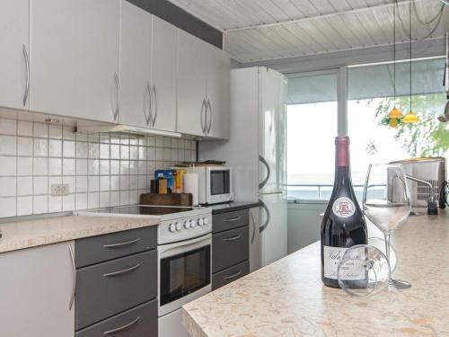 a bottle of wine sitting on a counter in a kitchen at 6 person holiday home in Bjert-By Traum in Bjert Strand