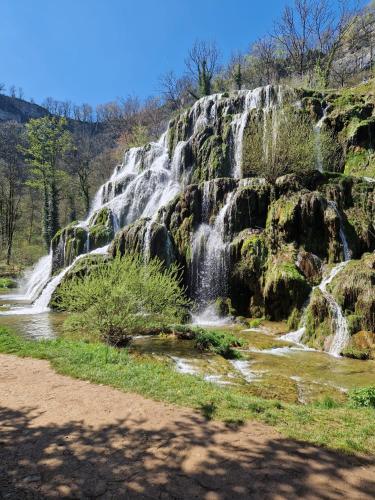 a waterfall on the side of a mountain at Gîte des trois petits oiseaux in Picarreau