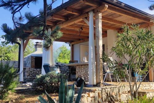 a wooden pergola on a house at Rare find! Dogs Welcome Secluded Comfy House Krk in Šilo