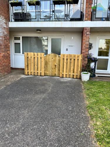 a wooden fence in front of a house at Flat 3 Seaside Haven in Hunstanton