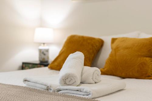 a towel animal sitting on top of a bed at Casa Palacio Rufina & Jardines in Jerez de la Frontera