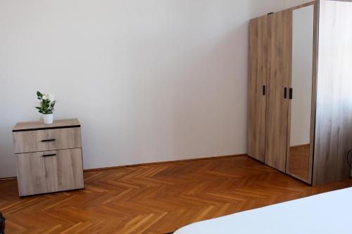 a room with a wooden cabinet and a door at Centrum Hostel in Pécs