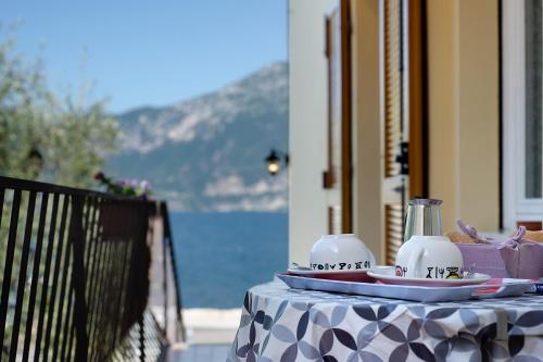 a table with a table cloth on a table with a view of the ocean at Appartamento Marilu Lake View in Brenzone sul Garda