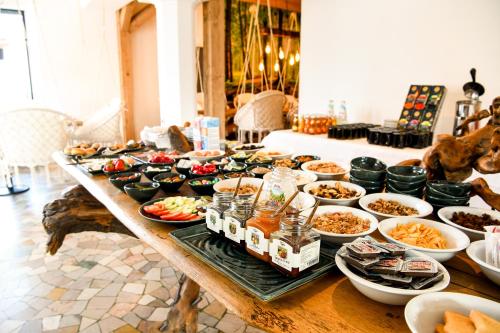 a table with a bunch of food on it at Guesthouse Rosengarten in Dobbiaco