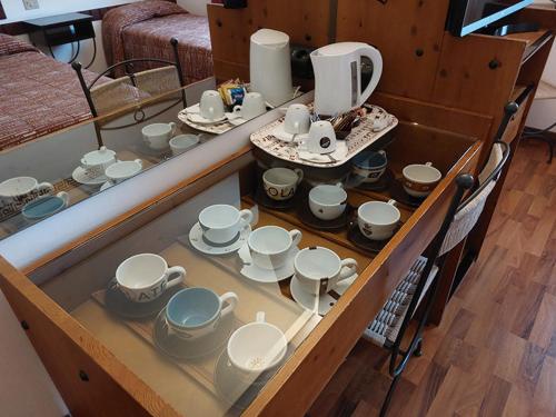 a table with a bunch of cups and dishes on it at Chocohotel in Perugia