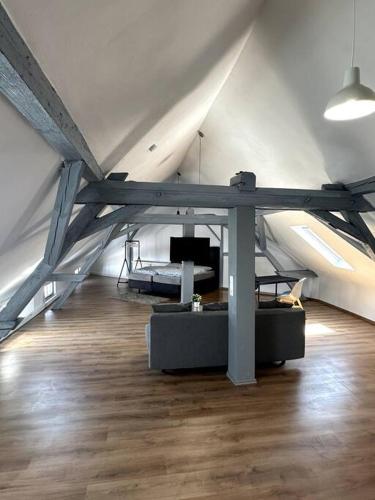 a room with a couch and a table in a ceiling at T-Apartments in Marktheidenfeld