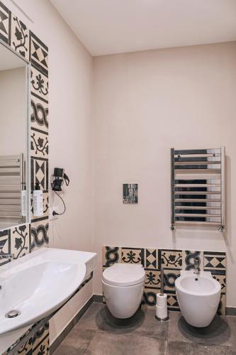 a bathroom with a tub and a toilet and a sink at La Smorfia in Naples