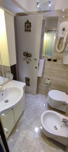 a bathroom with a sink and a toilet at Villa Arianna B&B in Taormina