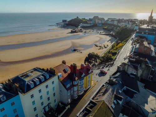 an aerial view of a beach with buildings and the ocean at Ocean House, Tenby in Tenby
