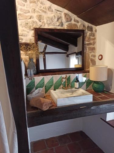 a bathroom counter with a sink and a mirror at Casa El Inglés in Mora de Rubielos