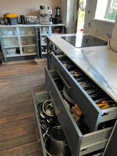 a kitchen with an open drawer in a counter top at Eclectic Barn - Pergola & Dog-Friendly Garden in Calne