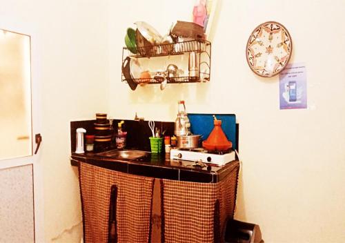 a kitchen with a counter with aperature at Studio near the sea for surfing lovers welcome in Safi