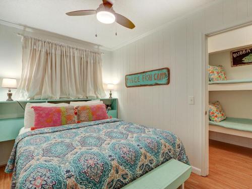 a bedroom with a bed and a ceiling fan at Beach and Racquet in Tybee Island