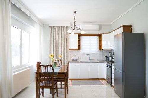 a kitchen with a table and a refrigerator at Raptis Guest House in Tsilivi