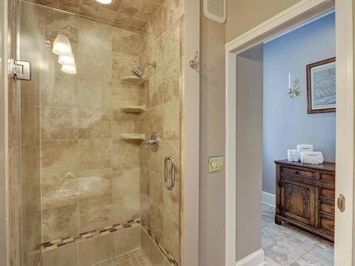 a bathroom with a shower with a glass door at Bird Baldwin Twelve Oaks in Savannah