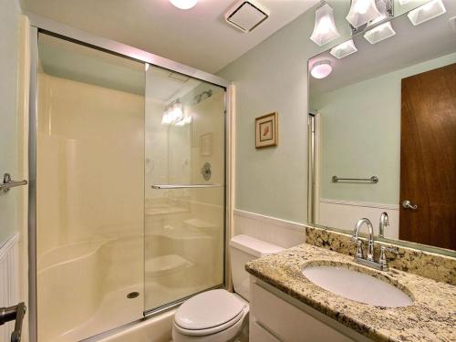 a bathroom with a shower and a toilet and a sink at Donna`s Escape in Tybee Island