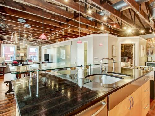 a kitchen with a large counter with a sink at Broughton Corner Loft in Savannah