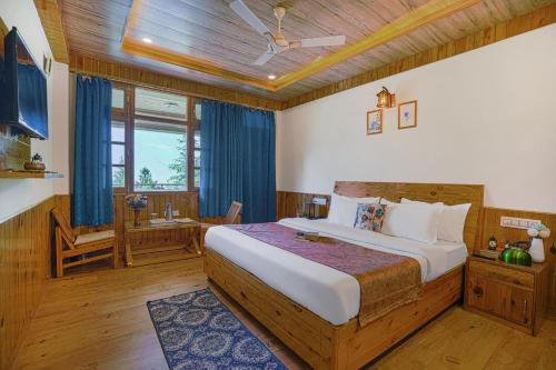 a bedroom with a large bed in a room at SaffronStays Kesar Villa, Manali - beautiful villa amidst an apple orchard - All clear roads in Manāli