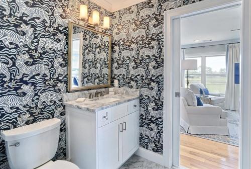 a bathroom with a sink and a mirror at El Rey Collection 2 in Tybee Island