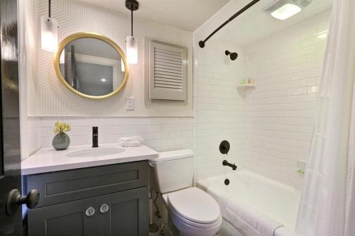 a bathroom with a sink and a toilet and a mirror at Isaac LaRoche Garden in Savannah