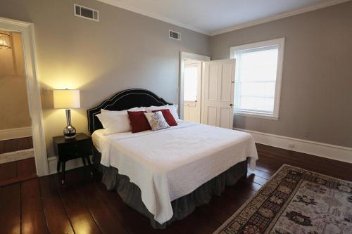 a bedroom with a large bed and a window at Oglethorpe Manor Main House in Savannah