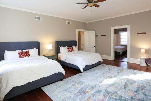 a bedroom with two beds and a ceiling fan at Oglethorpe Manor Main House in Savannah