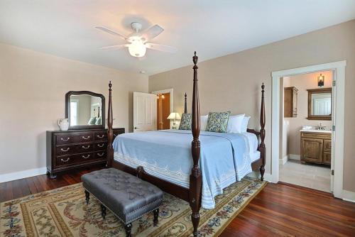 a bedroom with a bed and a dresser and a mirror at Change Of Place Main House in Savannah