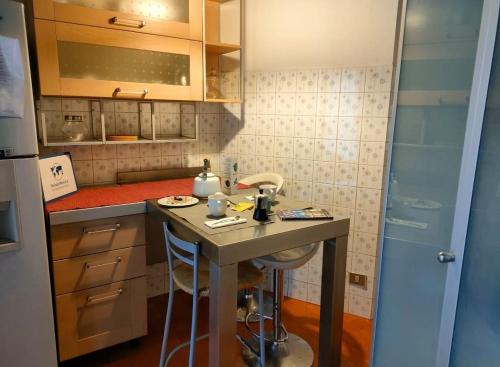 a small kitchen with a counter and a table at Villa Louise by Holiday World in Aci Castello