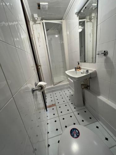 a white bathroom with a toilet and a sink at Georgian House Hotel in Derby