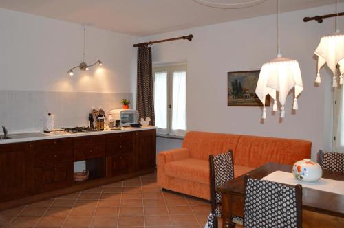 a kitchen and living room with a couch and a table at Agriturismo Tenuta Buon Respiro in Orvieto