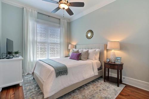 a bedroom with a bed and a ceiling fan at Congress Street Retreat in Savannah