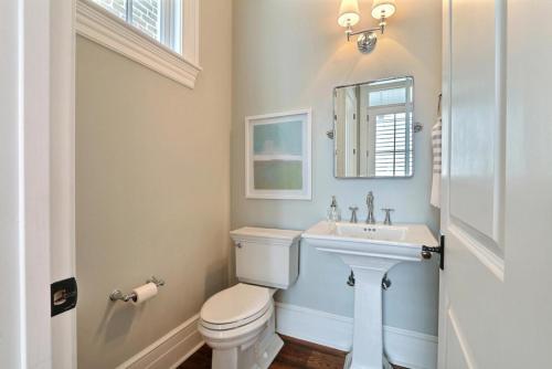 a bathroom with a white toilet and a sink at Congress Street Retreat in Savannah